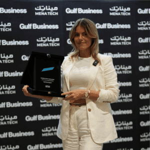 A Comarch representative proudly holding the MENA Tech Editors' Choice 2023 award for Comarch Loyalty Management, celebrating software excellence