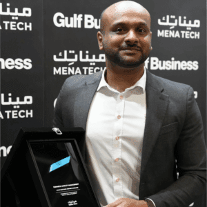 A Comarch team member showcasing the MENA Tech Editors' Choice 2023 award for Comarch Loyalty Management, recognizing best loyalty software.