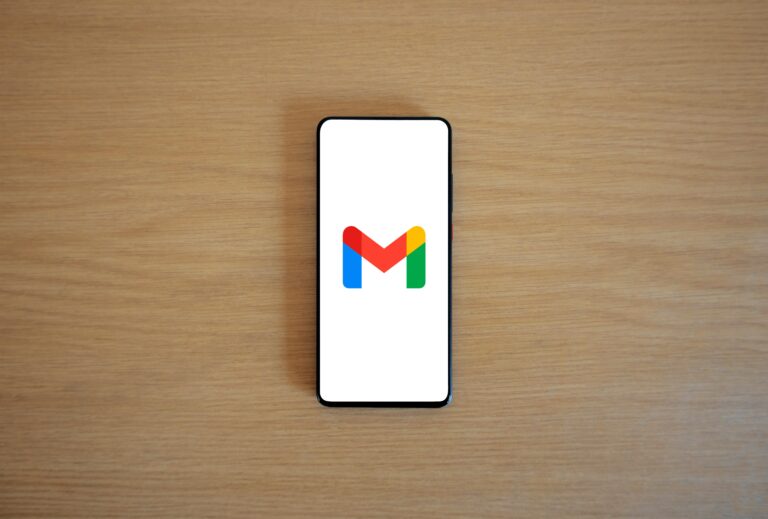 smartphone with gmail background placed on a table